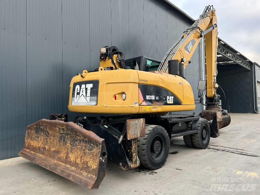 CAT M318D MH Materialumschlag